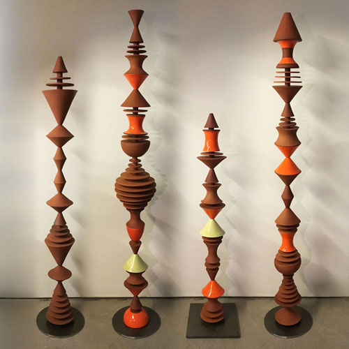 Garden Cones sculptures, composed from modular handmade pieces, are at home both indoors and out. With a nod to mid-century modern, the geometric forms repeat playfully, complementing both plants and architecture. 60 inches tall, terra cotta or white stoneware, pottery decor.